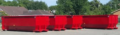four red rental dumpsters